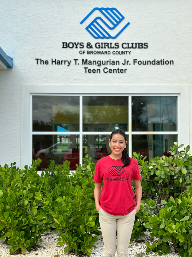 Club member in front of Harry T Manguarian Jr. Foundation Teen Center