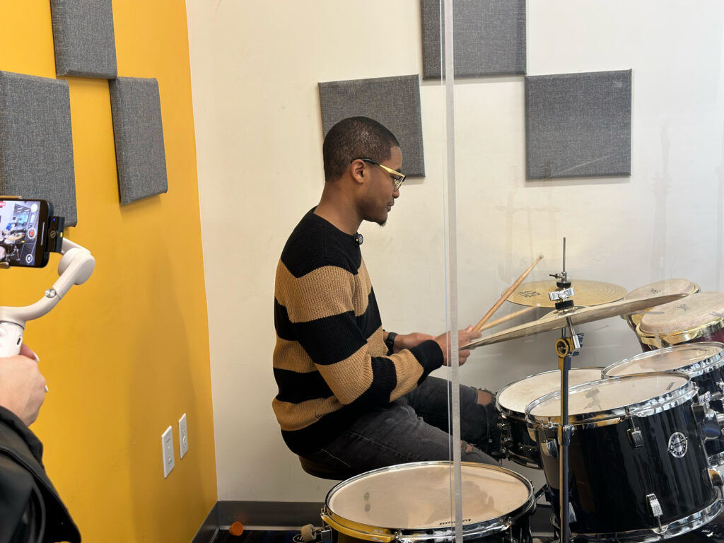 Markus Howell playing the drums at a Boys and Girls Club in Broward County