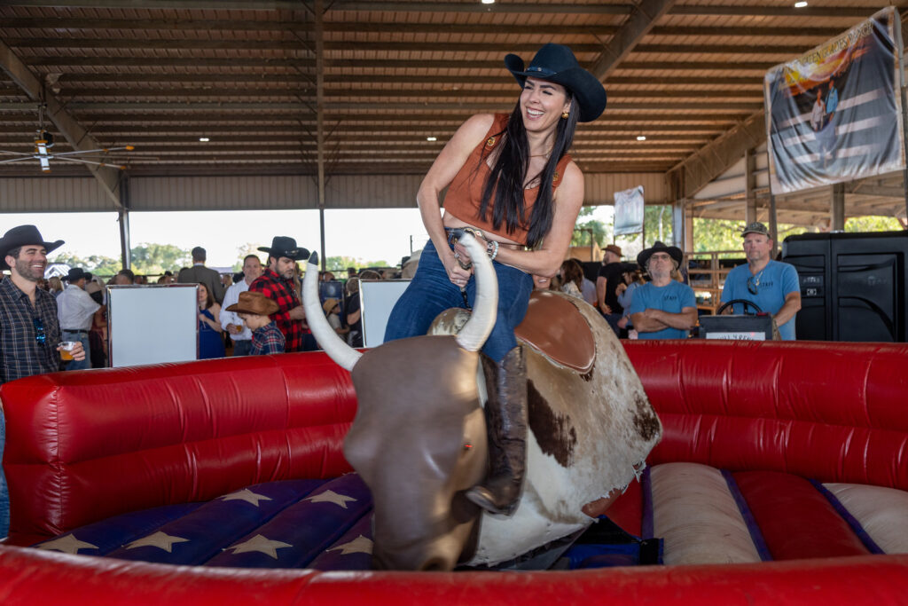 Ranch Roam guest riding a mechanical bull.