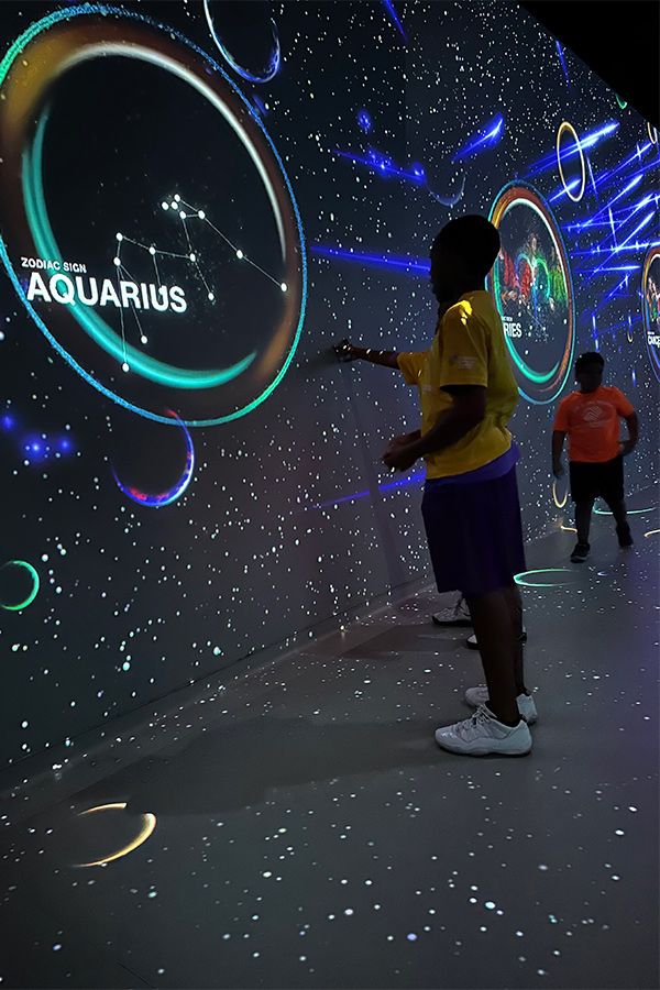 Boys and Girls Club Members inside the South Florida PBS/Da Vinci, looking at constellation of Aquarius