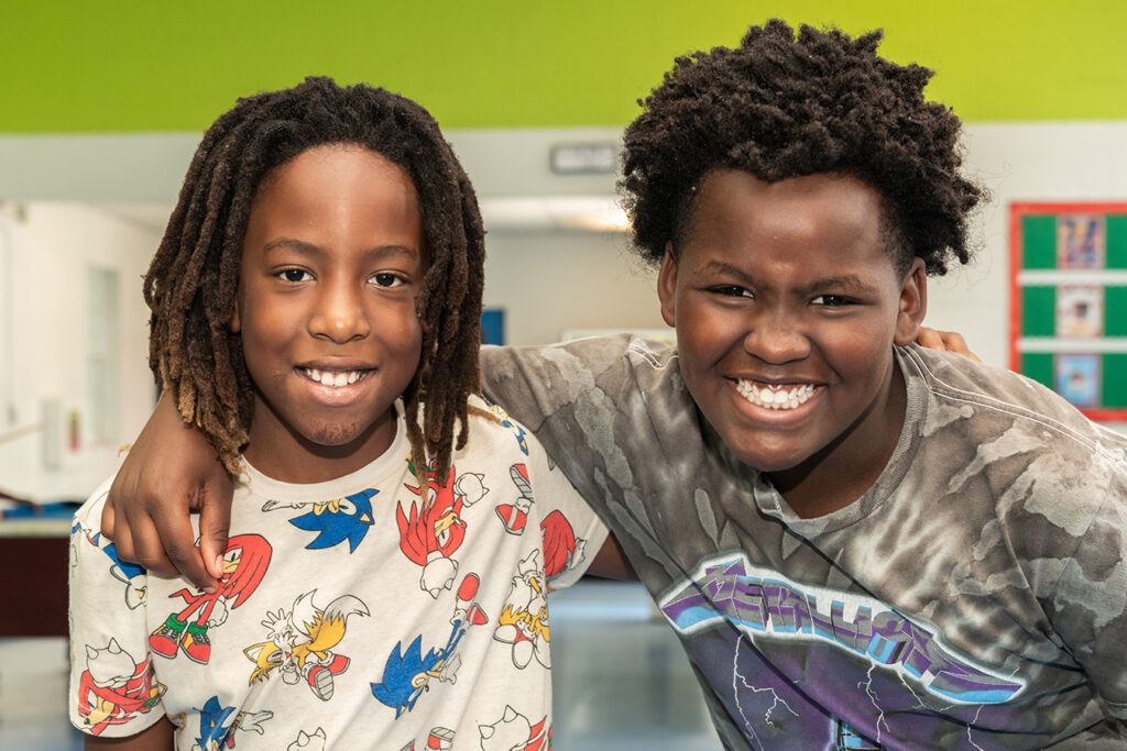 Two Boys and Girls of Broward County Club Members posing together.