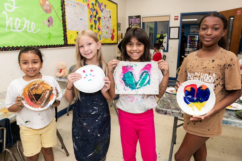 Boys and Girls Club members holding their summer projects