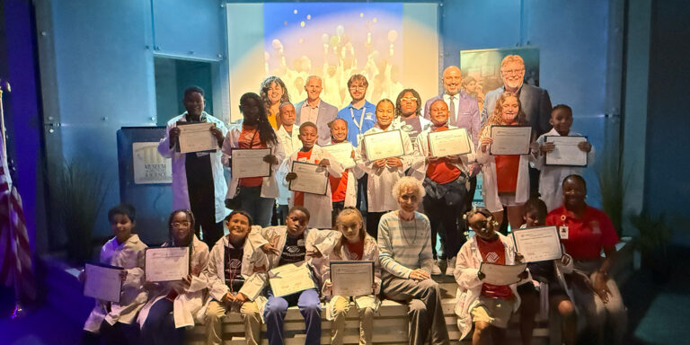 Boys and Girls Club of Broward County club members posing in a group picture at the Museum of Discovery & Science with MODs and BGCBC staff, along with the Co-CEOs of the BGCBC Matt Organ and Chris Gentile.