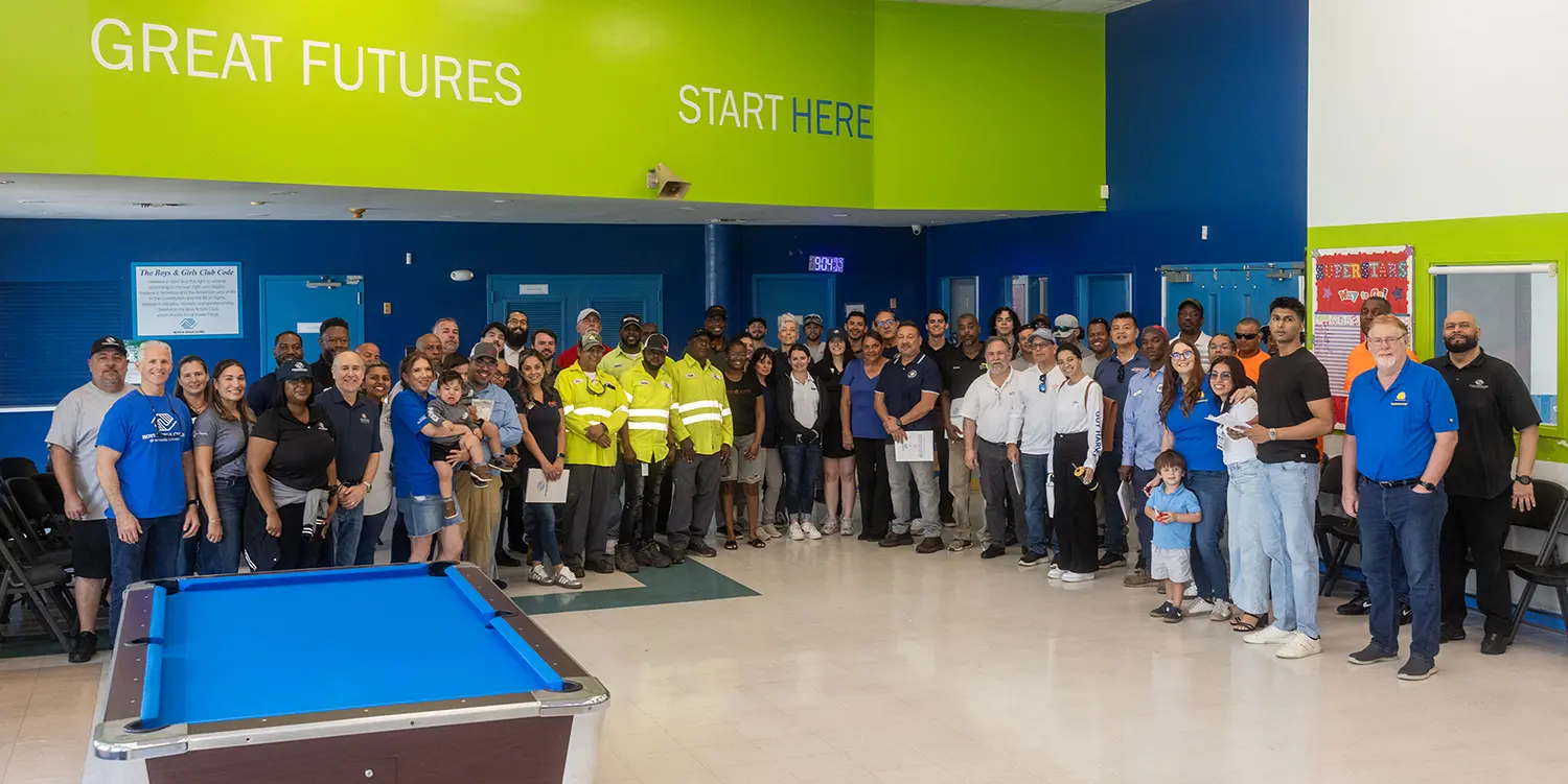 A group photo of the Attendees, Industry Professionals, and Staff from the General's Construction Career Day. Above them is a green wall that reads "Great Futures Start Here"