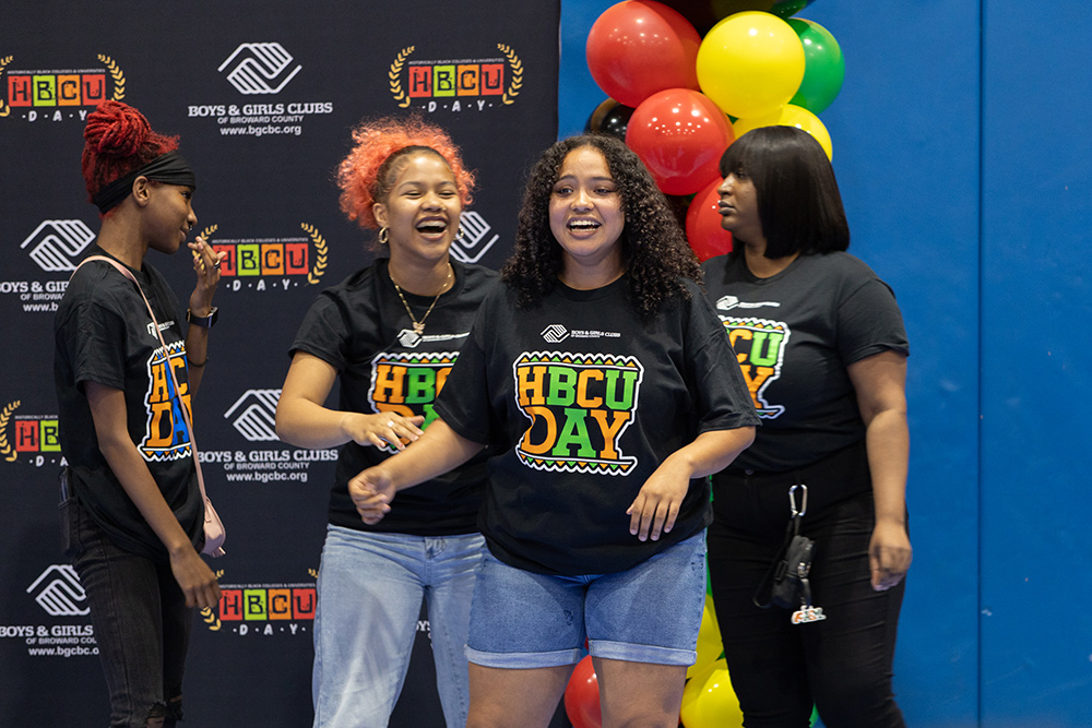 Three BGCBC Club Members and a BGCBC Staff member at the event all smiling and wearing the Boys & Girls Clubs of Broward County HBCU Day shirts.