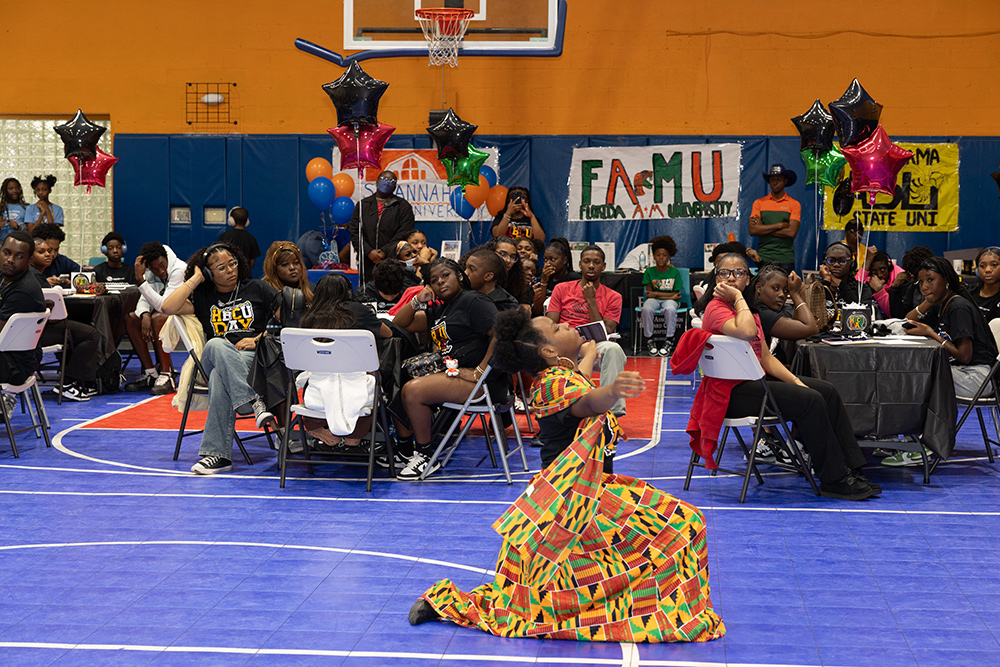 A Performer at the HBCU Day event being watched by the club members.
