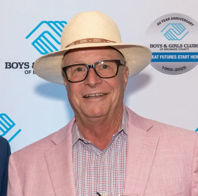 Doug Cady smiling in front of a branded backdrop that features the BGCBC main Logo and the BGCBC 60th anniversary logo.