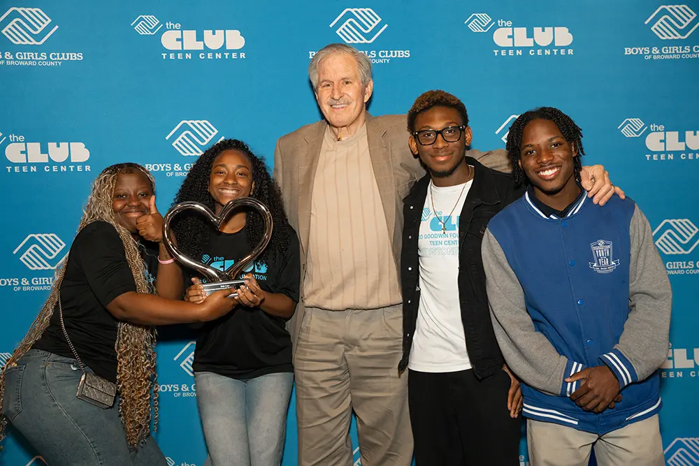 Bob Case smiling with Nashon and other Teen Club Members.