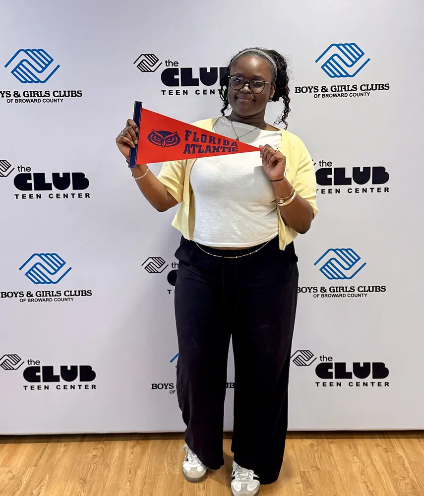 A BGCBC club member holding up a Florida Atlantic pennant