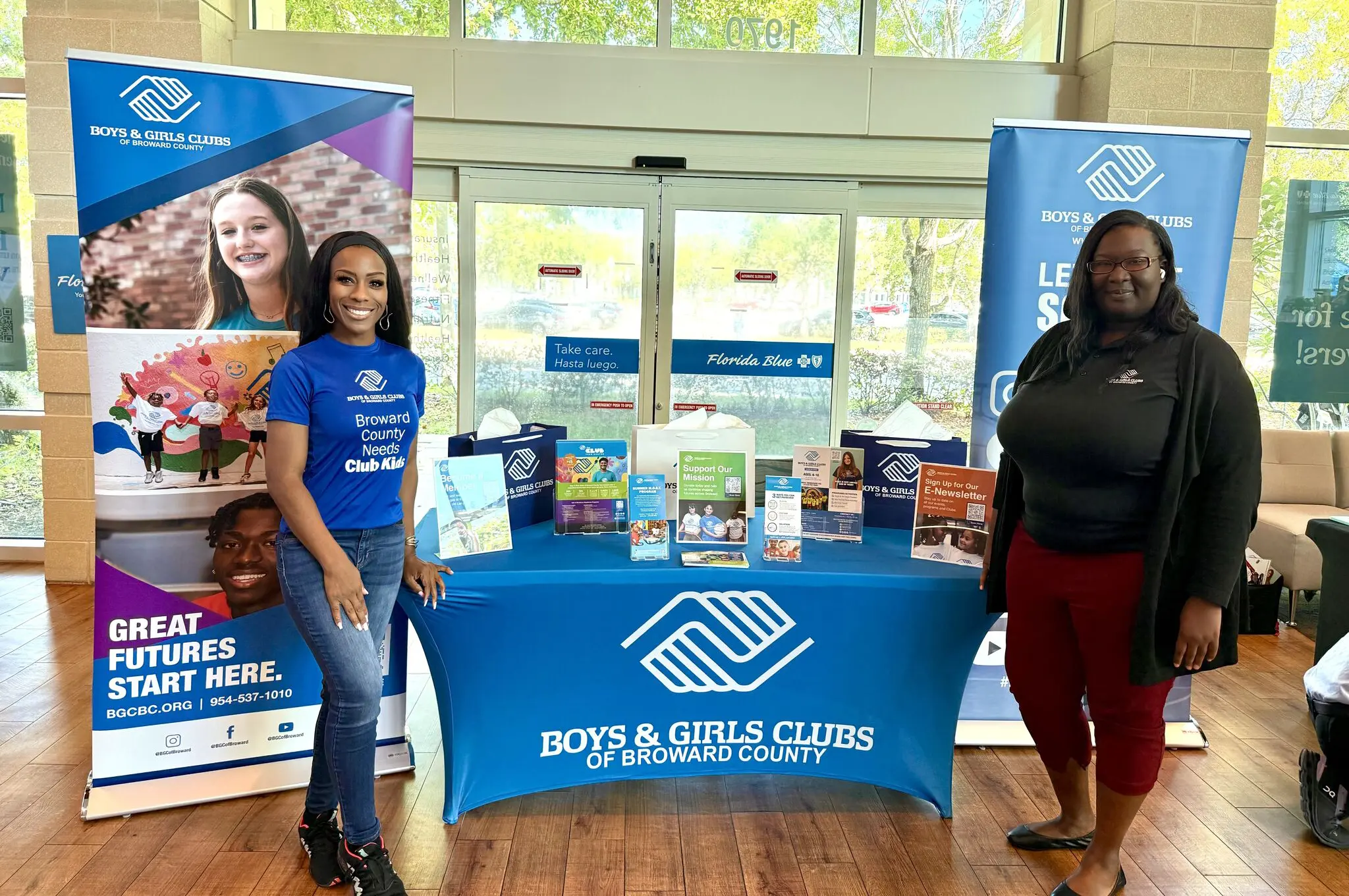 BGCBC staff posing alongside the BGCBC booth at the event.