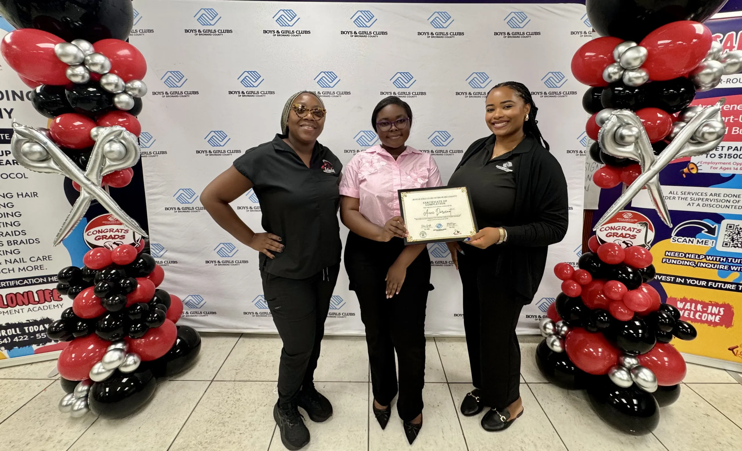 One of the BGCBC Club member graduates posing with BGCBC staff with their certificate.