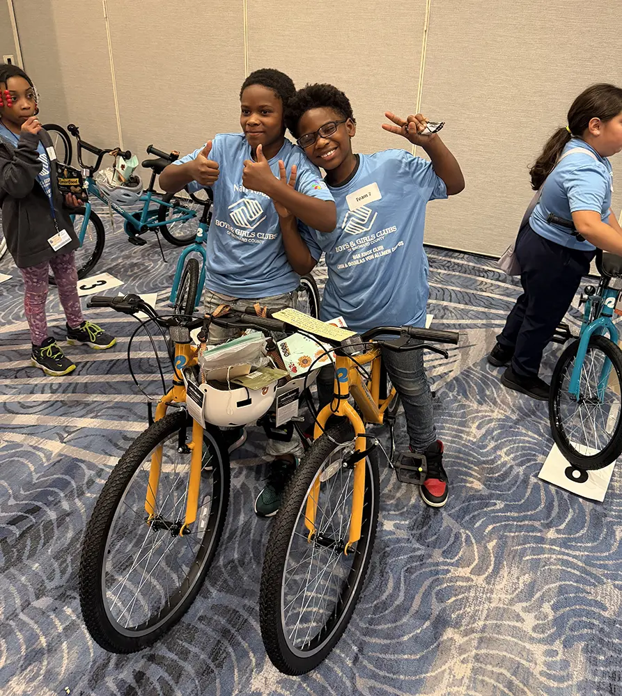 Two BGCBC Club members on bikes posing next to each other