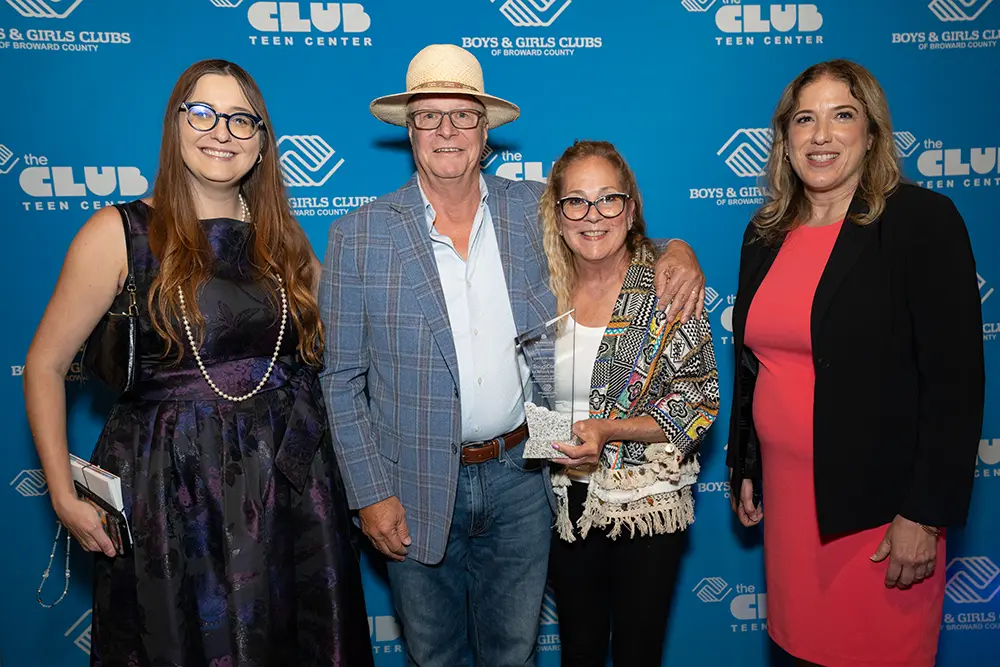 Doug Cady pictured smiling with his award, Sue Cady, Krystyna Ermer, and Annie Mecias-Murphy