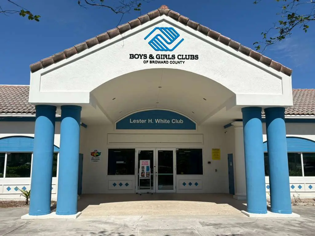 The white exterior with blue pillars of the Lester H. White / NFL Yet Boys & Girls Club of Broward County