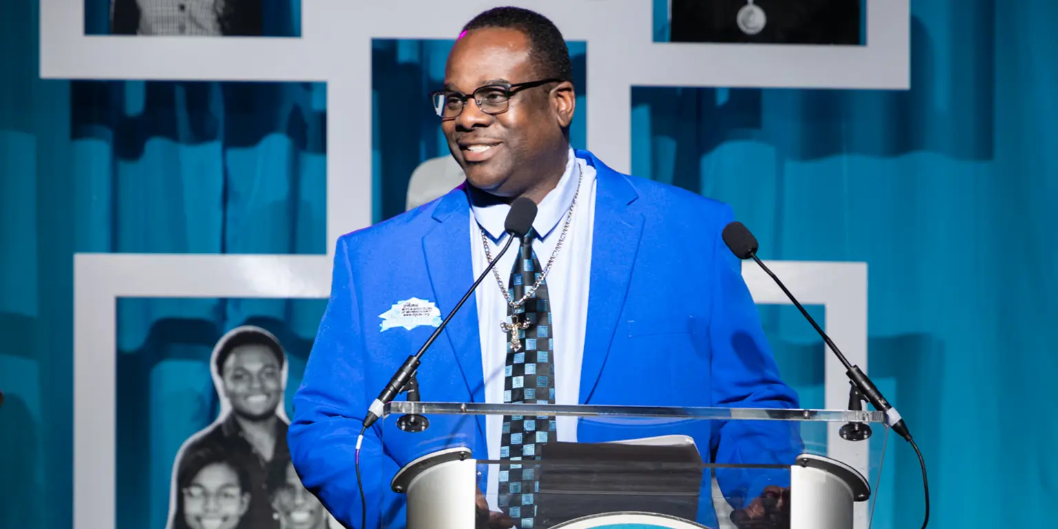 Markes Thomas on stage after being inducted into the Boys & Girls Club Hall of Fame.