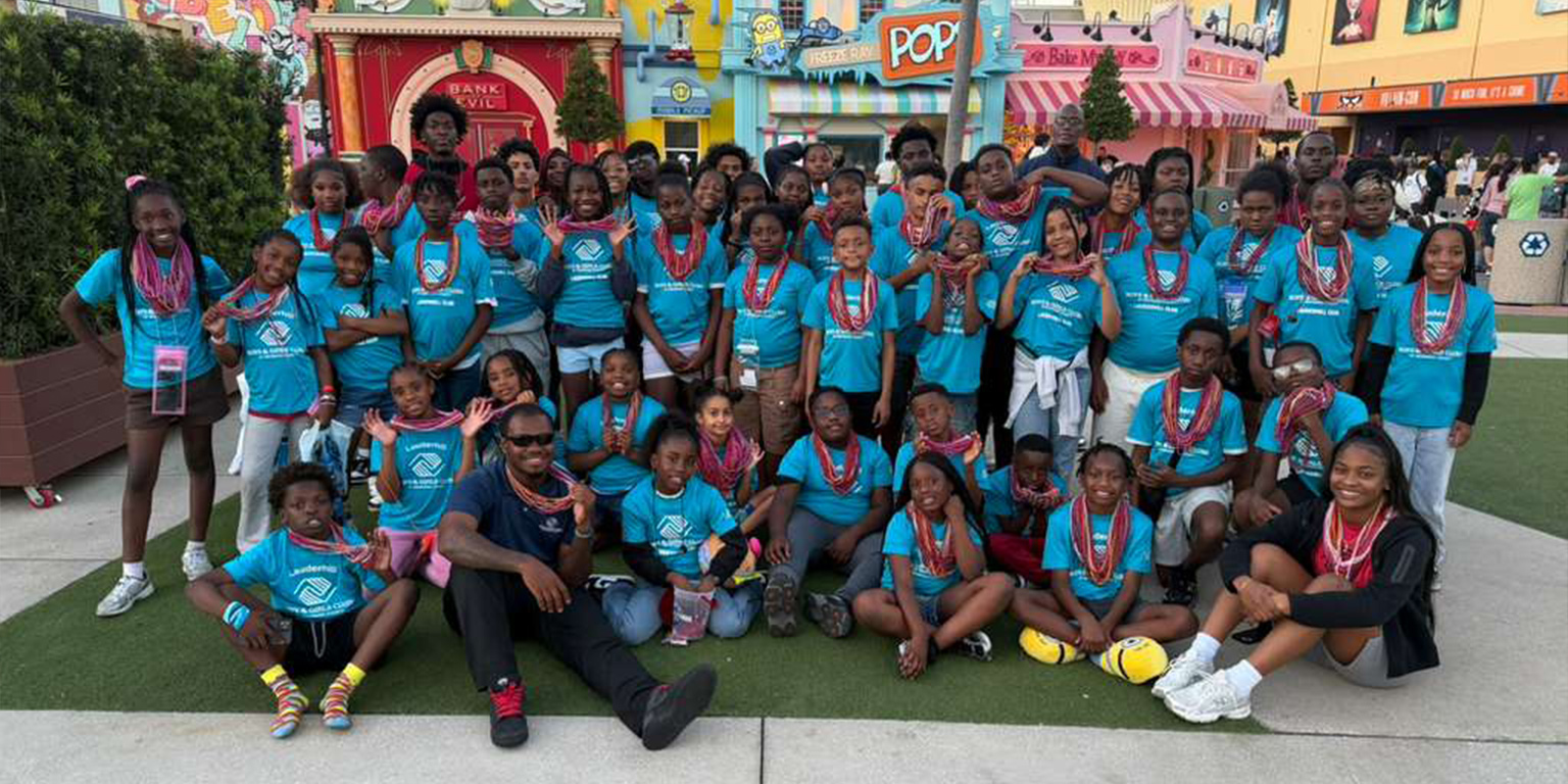 A group photo of Boys & Girls Club of Broward County Club members and staff on a field trip wearing blue BGCBC shirts.