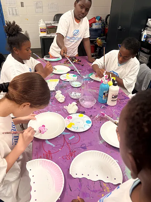 BGCBC Club members painting paper plates that have been cut in half to make paper jellyfish
